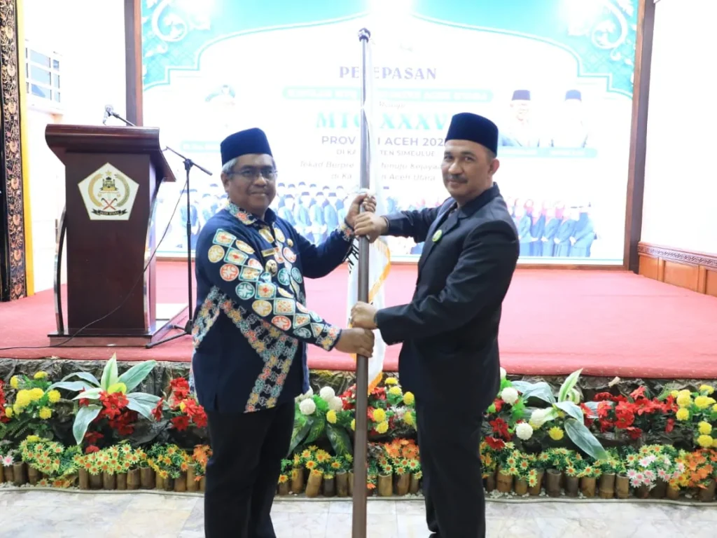 Pj Bupati Mahyuzar serahkan Benddera petaka MTTQ kepada Plt Kepala Dinas Syariat Islam Kabupaten Aceh Utara Hadaini, SSos di pendopo Bupati
